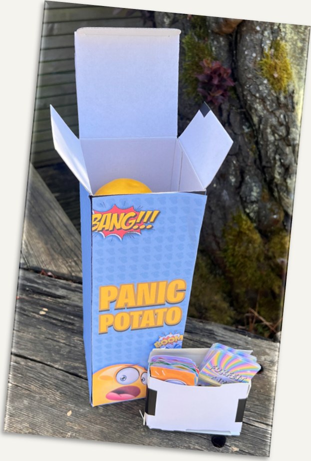 The printed Panic Potato box, open, with a foam potato and card tray