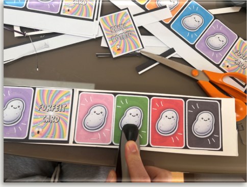 Cutting out the printed potato and forfeit cards
