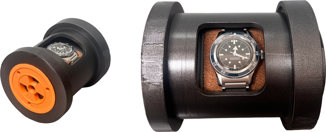Two printed capsules, one with the watch facing forward behind the glass panel